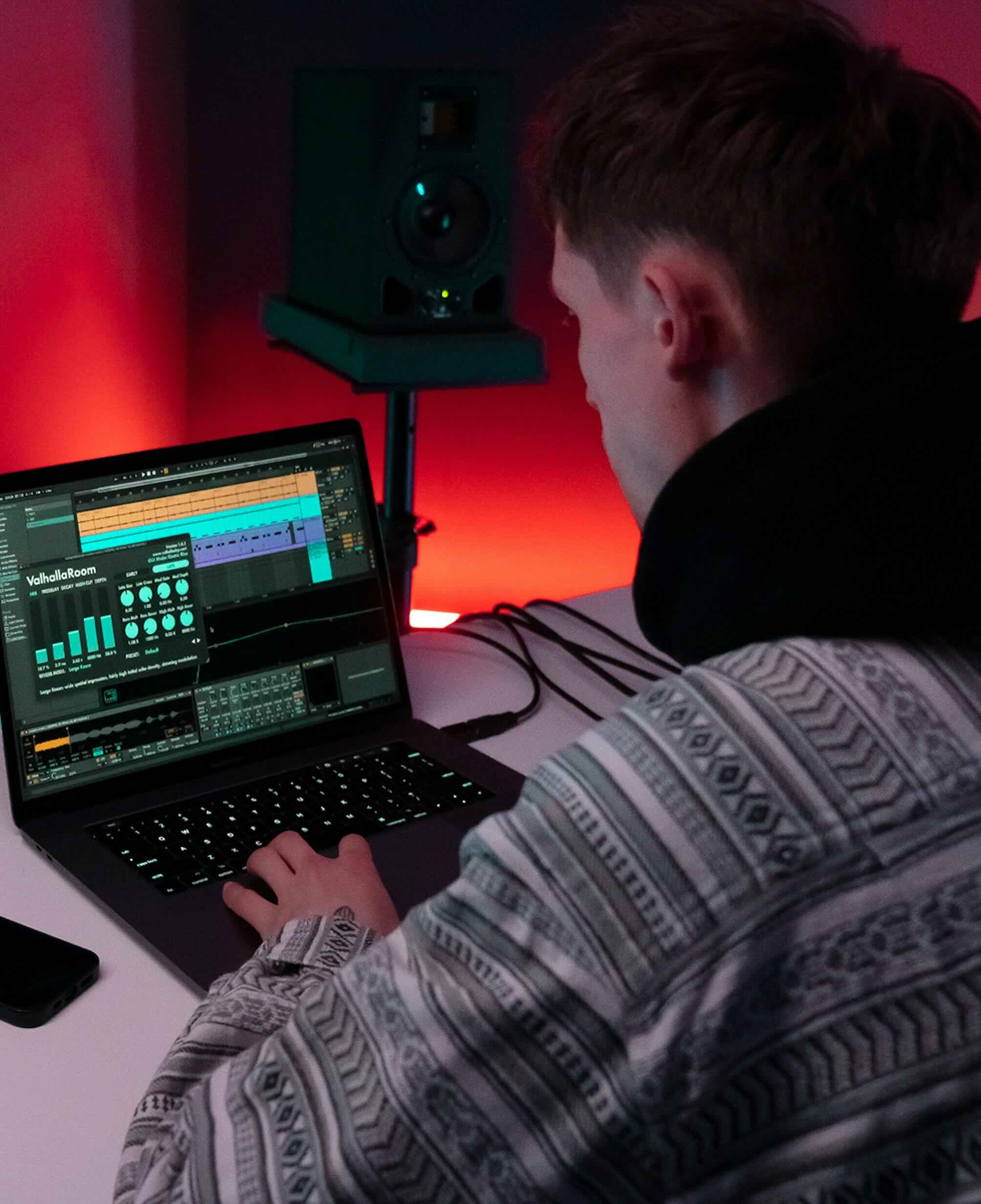 Image of a person using a laptop for music production at Production Music Tools (PMT). Keywords: PMT, Production Music Tools, music producer, laptop.